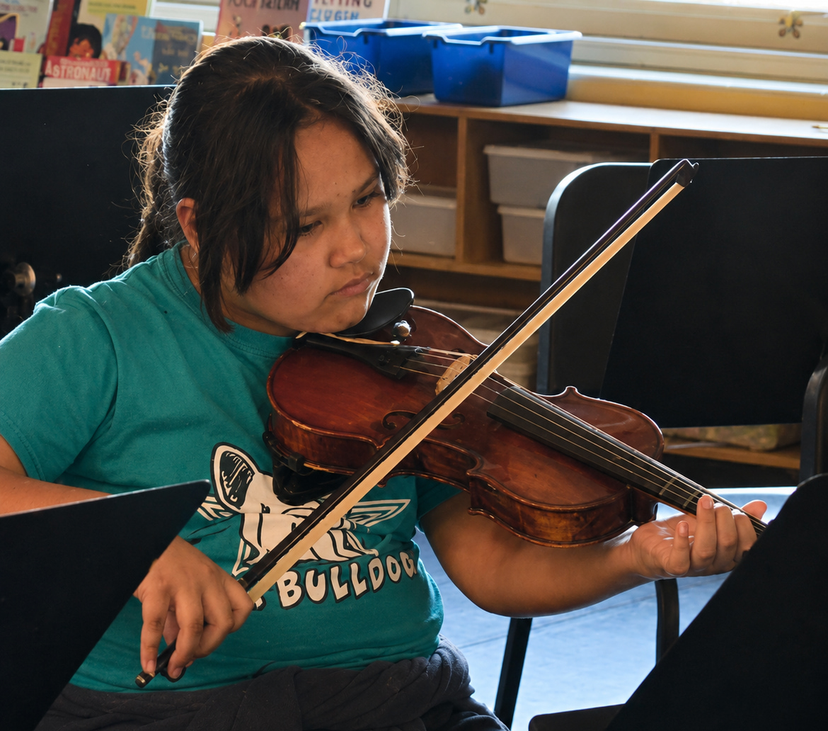 Student playing violin during Brandi Hart musical enrichment workshop